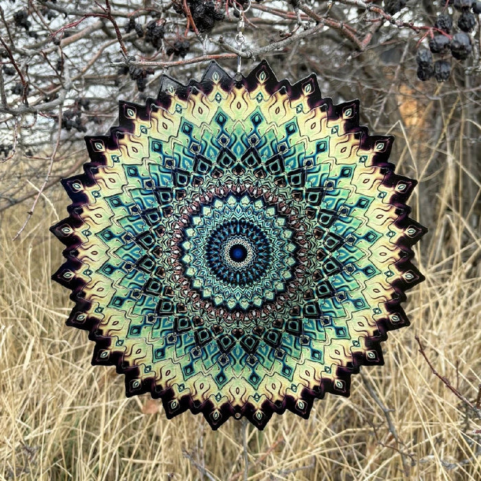 A circular design made of paper, displaying a blend of blue and green hues in a decorative pattern.