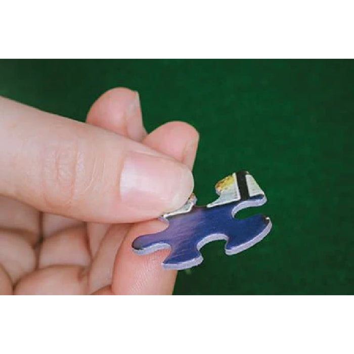 A close-up of a person’s hand holding a small blue puzzle piece, illustrating the concept of fitting pieces together.
