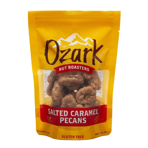 Ozark Nut Roasters Salted Caramel Pecans in a bright yellow resealable stand-up pouch with a clear window showing the pecans inside, on a light gray background.