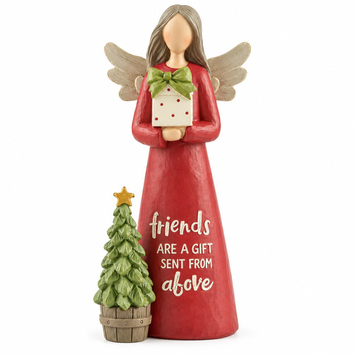 Angel figurine in a red dress holding a gift beside a Christmas tree, with “Friends are a gift sent from above”