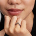 Close-up of a woman’s hand wearing the Pandora Disney Maleficent Ring in sterling silver with dark stones.
