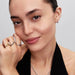 A woman’s hand wearing the Pandora Disney Maleficent Ring in sterling silver with dark stones, styled with other rings.