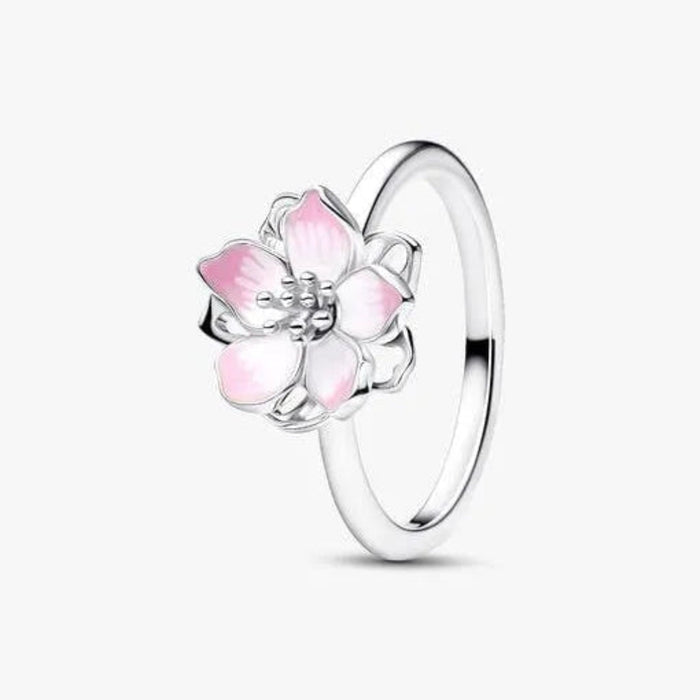 Silver ring with pink flower design on a white background