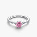 Elegant Pandora flower ring adorned with a pink sapphire, crafted in white gold.