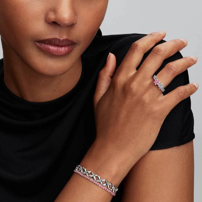 A stunning Pandora flower ring with a pink sapphire centerpiece, made of white gold.
