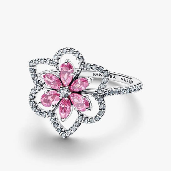 A stunning pink flower ring featuring sparkling diamonds and pink sapphires, elegantly crafted for a luxurious look.