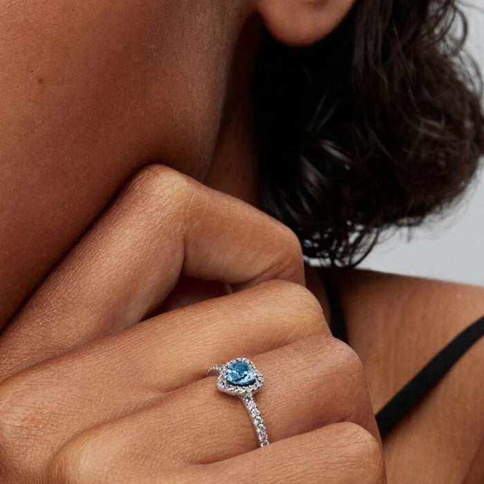 Hallmark Pandora Rings A blue topaz ring embellished with a circle of white diamonds.