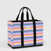 A stylish tote bag with colorful stripes and black handles, suitable for everyday use.
