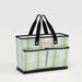 A tote bag featuring a design of green leaves on a light background.