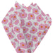 Close‑up of white tissue paper featuring bold pink mod floral pattern