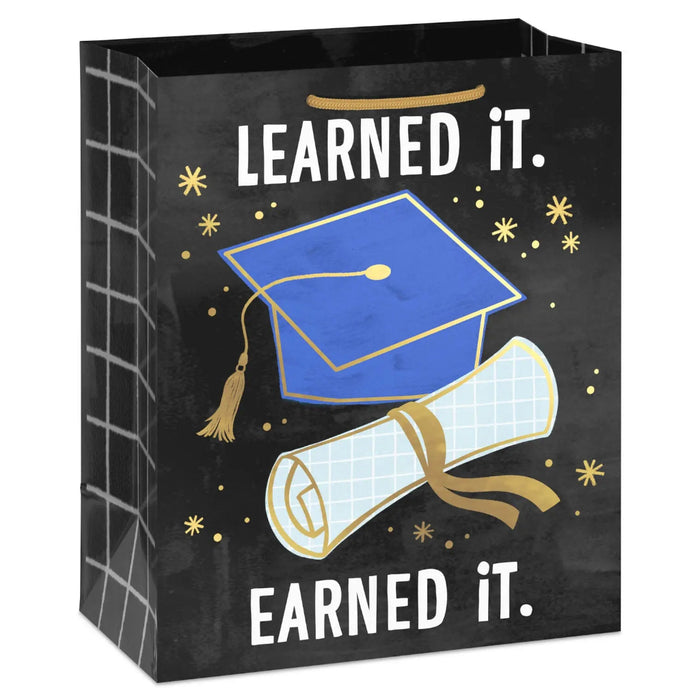Medium graduation gift bag with blue mortarboard and diploma design, gold foil accents, and “Learned it. Earned it.”