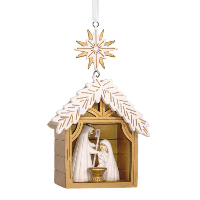 Decorative nativity scene ornament with a star on a white background