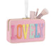 Pink makeup case with 'LOVELY' text and makeup brushes on a white background