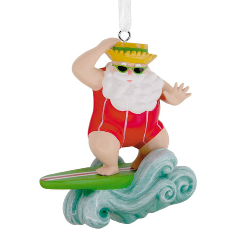 Santa Claus ornament surfing on a wave with a yellow hat and red swimsuit.