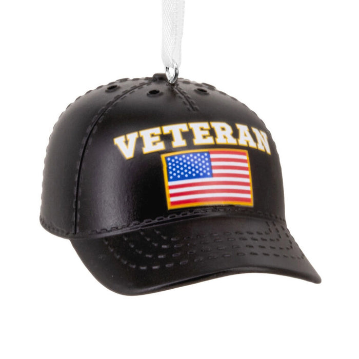 Black cap ornament with 'VETERAN' and American flag on a white background