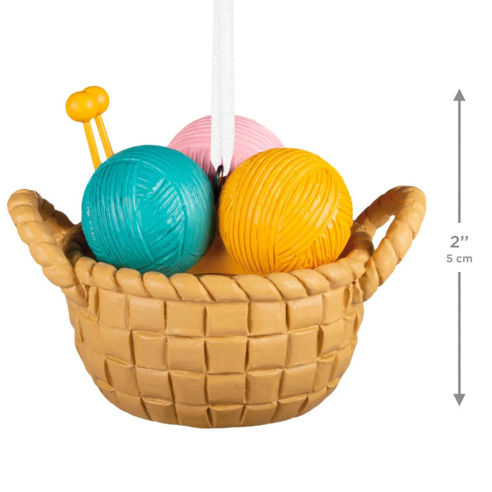 Hallmark Knitting Basket Christmas ornament featuring a resin basket filled with colorful yarn skeins and knitting needles for a cozy holiday display.
