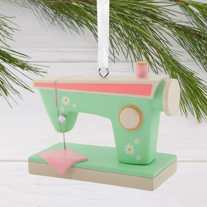 Hallmark Retro Sewing Machine Christmas ornament featuring a vintage-inspired green and pink sewing machine with colorful flower accents.
