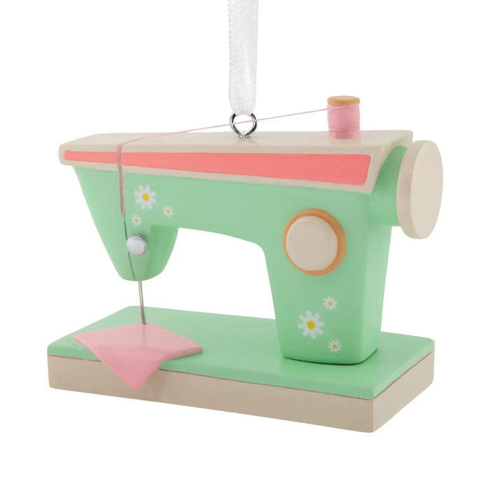 Hallmark Retro Sewing Machine Christmas ornament featuring a vintage-inspired green and pink sewing machine with colorful flower accents.