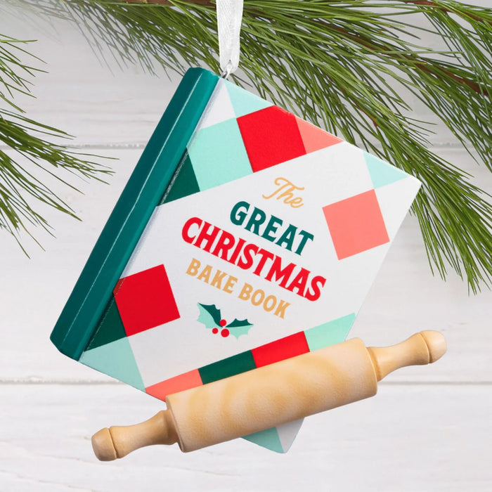 Hallmark Christmas Cookbook ornament featuring a red and green plaid cookbook with “The Great Christmas Bake Book” message and a classic rolling pin.