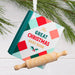 Hallmark Christmas Cookbook ornament featuring a red and green plaid cookbook with “The Great Christmas Bake Book” message and a classic rolling pin.