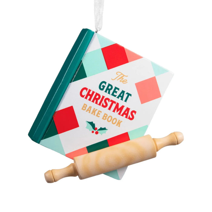 Hallmark Christmas Cookbook ornament featuring a red and green plaid cookbook with “The Great Christmas Bake Book” message and a classic rolling pin.