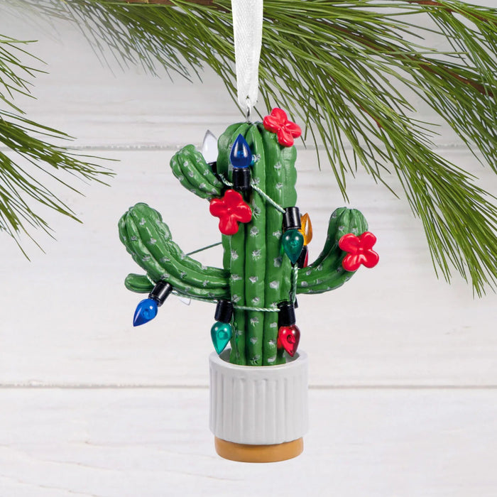 Hallmark Seasonal Cactus Christmas ornament featuring a potted cactus decorated with festive Christmas lights for a desert-inspired holiday display.