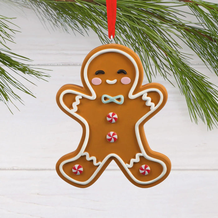 Hallmark Gingerbread Man Cookie Christmas ornament featuring a smiling frosted gingerbread man with peppermint candy buttons and a hanger attachment.