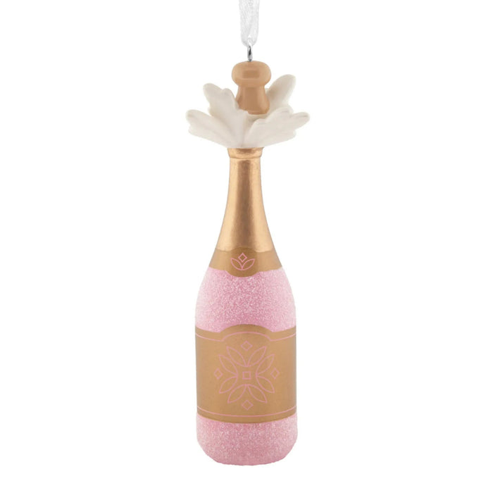 Hallmark Pink Champagne Christmas ornament featuring a gold-wrapped bottle with sparkling pink champagne bubbles bursting from the cork.