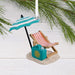 Hallmark Retired and Happy Christmas ornament featuring a beach chair, umbrella, sand, and beach bag with “Retired & Happy” message.