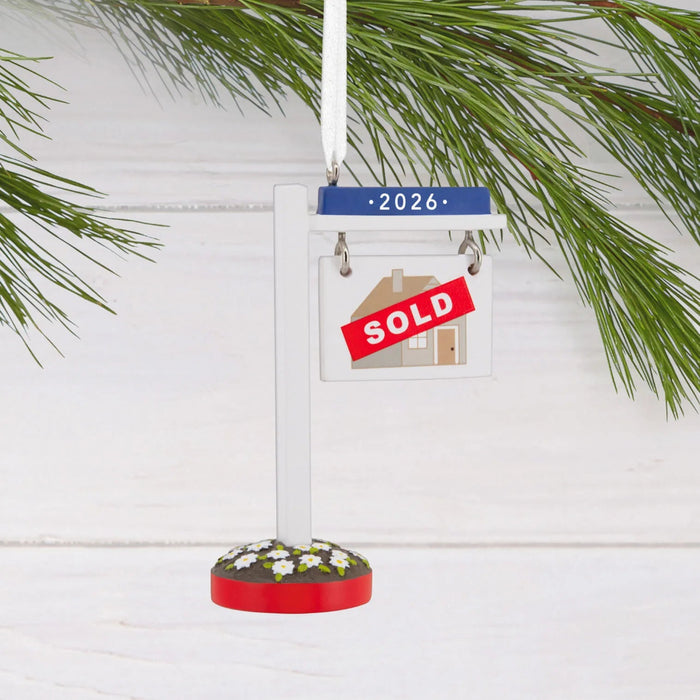 Hallmark New Home Sold 2025 Christmas ornament featuring a year-dated real estate sign with “Sold 2026” message for new homeowners.