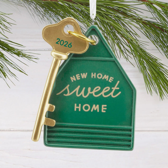 Hallmark New Home Sweet Home Key 2026 Christmas ornament featuring a gold house key with a green house-shaped keychain and year-dated message.