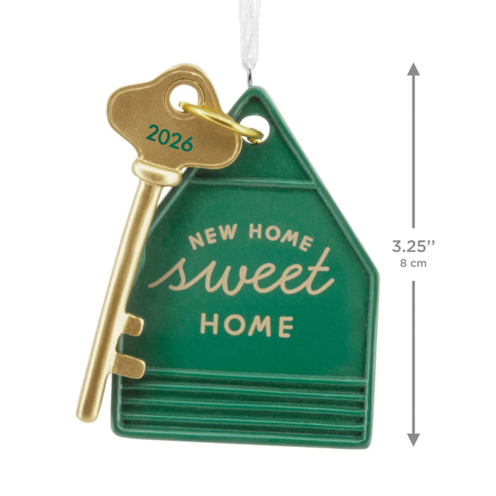 Hallmark New Home Sweet Home Key 2026 Christmas ornament featuring a gold house key with a green house-shaped keychain and year-dated message.