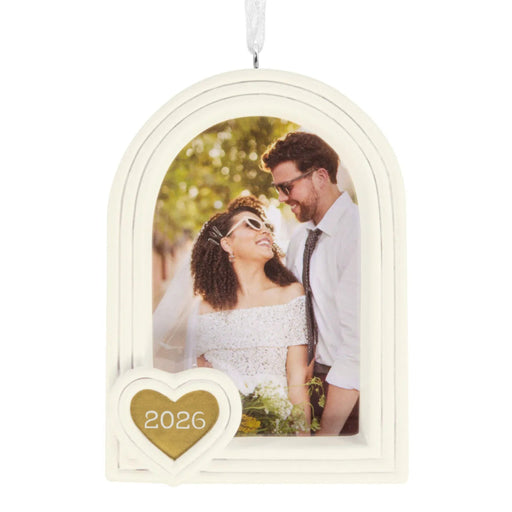 Hallmark Wedding 2026 Christmas ornament featuring a white arched photo frame with a gold heart attachment and year-dated 2026 design for newlyweds.