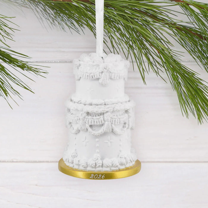 Hallmark Tiered Wedding Cake 2026 Christmas ornament featuring a two-tiered white wedding cake with ornate frosting details and a gold year-dated platter.