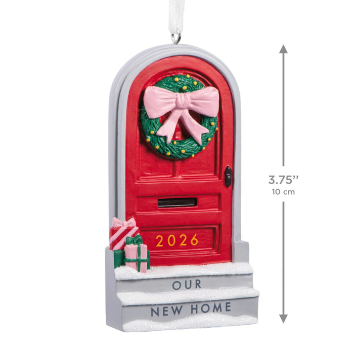 Hallmark Our New Home 2026 Christmas ornament featuring a red front door with a festive wreath, snow-covered steps, and wrapped gifts.