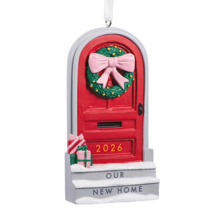 Hallmark Our New Home 2026 Christmas ornament featuring a red front door with a festive wreath, snow-covered steps, and wrapped gifts.