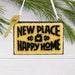 Hallmark New Home 2026 Christmas ornament featuring a resin doormat with “New Place, Happy Home 2026” message and a year-dated house key.