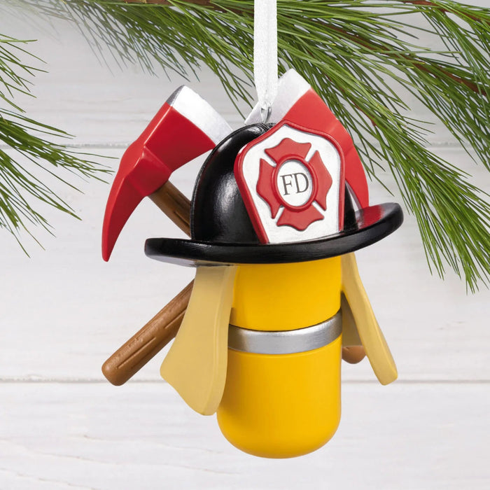Hallmark Firefighter Gear Christmas ornament featuring a firefighter helmet, air tank, and crossed axes in a detailed resin design.