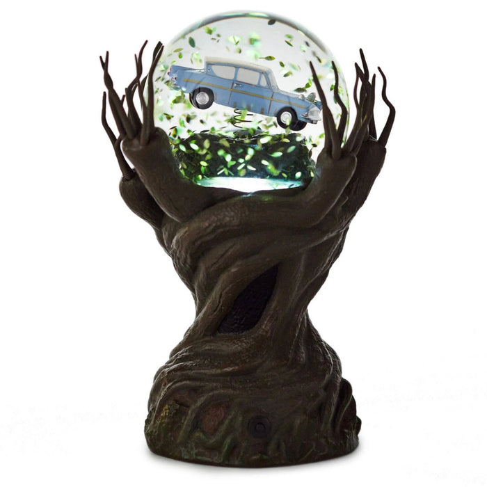Harry Potter Whomping Willow snow globe featuring illuminated LED lighting, animated motion, swirling glitter, and a detailed magical tree scene inspired by the Wizarding World.