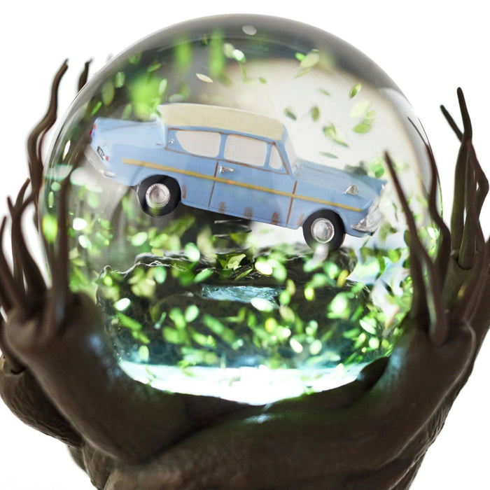 Harry Potter Whomping Willow snow globe featuring illuminated LED lighting, animated motion, swirling glitter, and a detailed magical tree scene inspired by the Wizarding World.