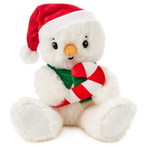 Plush snowman toy with a red Santa hat, green scarf, and candy cane on a white background