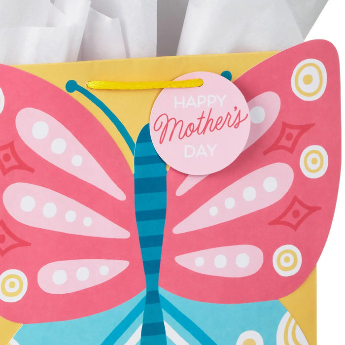 Close‑up of large yellow Mother’s Day gift bag showing pink and blue die‑cut butterfly and “Happy Mother’s Day” tag