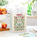 Floral Mother’s Day gift bag shown on a table with a card
