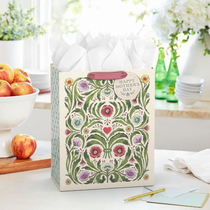 Ivory Mother’s Day gift bag with vintage botanical illustration displayed on a table beside a greeting card