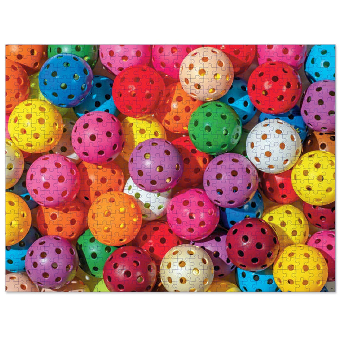 Prismatic Pickleballs 550-piece jigsaw puzzle featuring a colorful pattern of vibrant pickleballs.