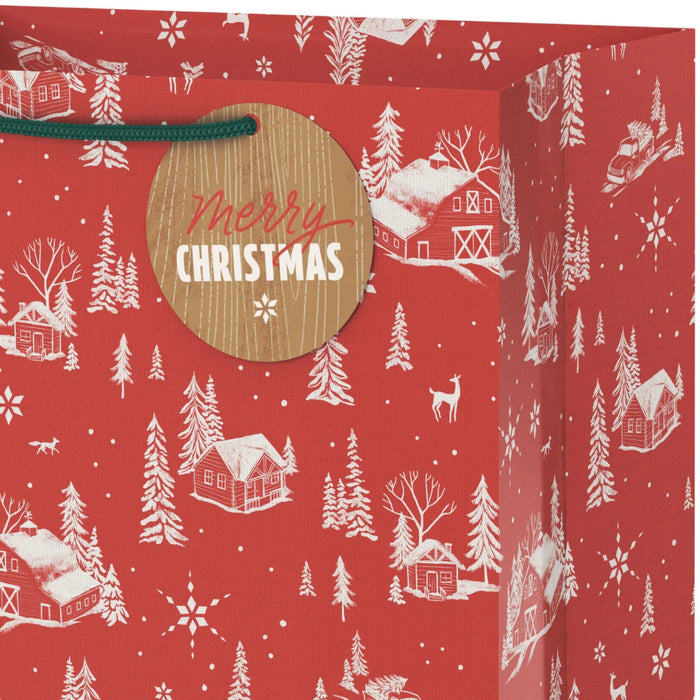 13-inch large Christmas gift bag featuring snowy barns on a red background with an included gift