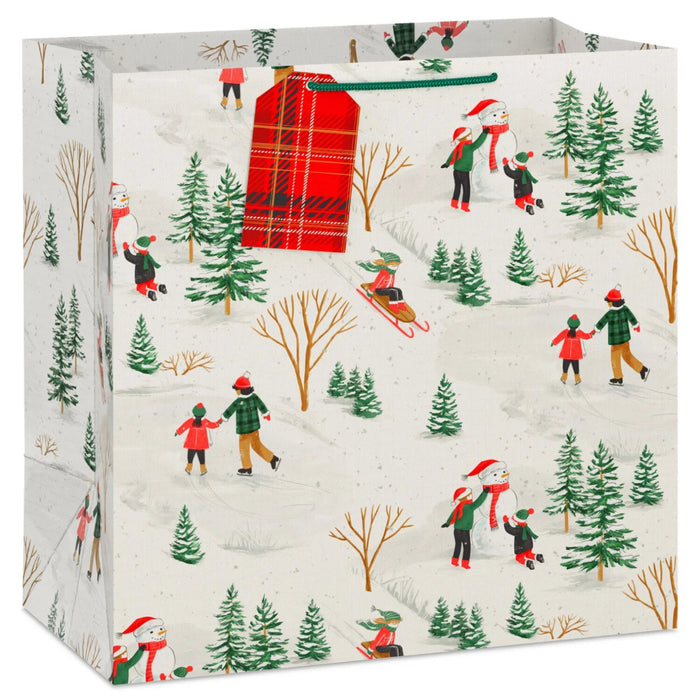 15-inch extra-deep Christmas gift bag featuring vintage sledding and skating artwork with an included gift tag.