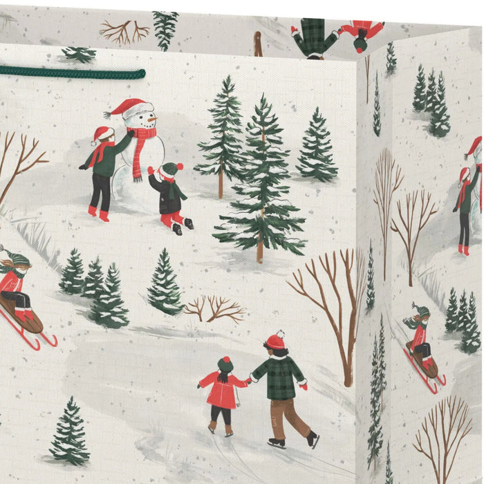 15-inch extra-deep Christmas gift bag featuring vintage sledding and skating artwork with an included gift tag.
