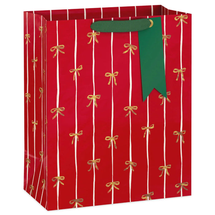 13-inch large Christmas gift bag featuring a red background with elegant gold bows for festive holiday gift presentation.