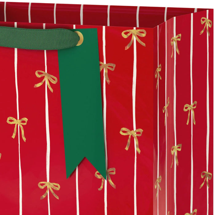 13-inch large Christmas gift bag featuring a red background with elegant gold bows for festive holiday gift presentation.